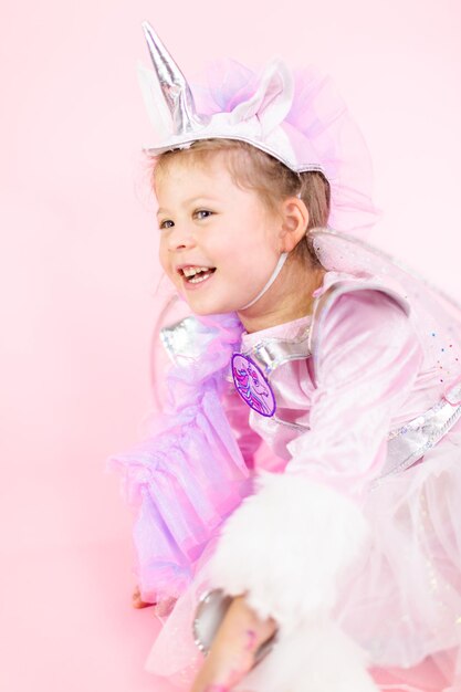 Premium Photo | Portrait of a little girl in glitter unicorn costume on ...