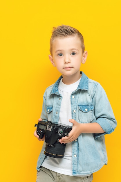 Premium Photo | Portrait of little kid holding digital photo camera