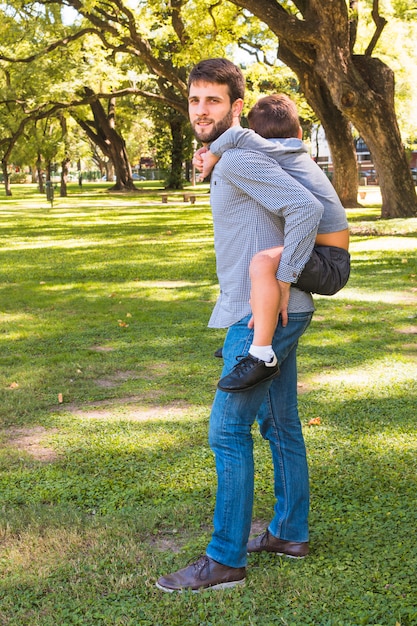 free-photo-portrait-of-a-man-giving-piggyback-ride-in-the-park