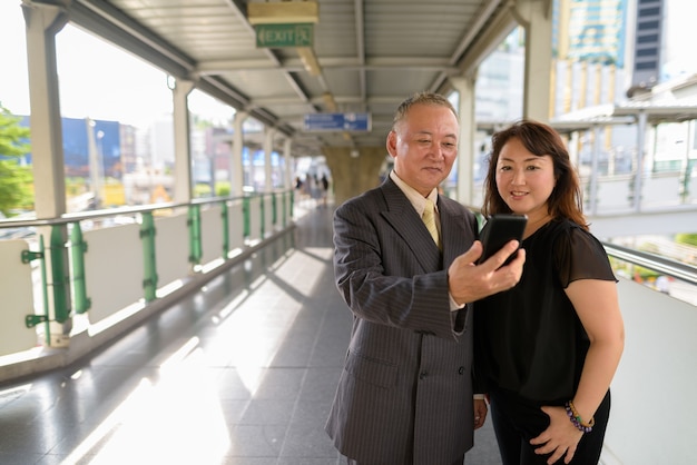 Portrait Of Mature Japanese Businessman And Mature Japanese Woman Exploring The City Of Bangkok Premium Photo
