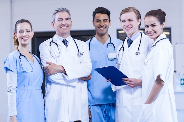 Premium Photo | Portrait of medical team standing together and smiling ...