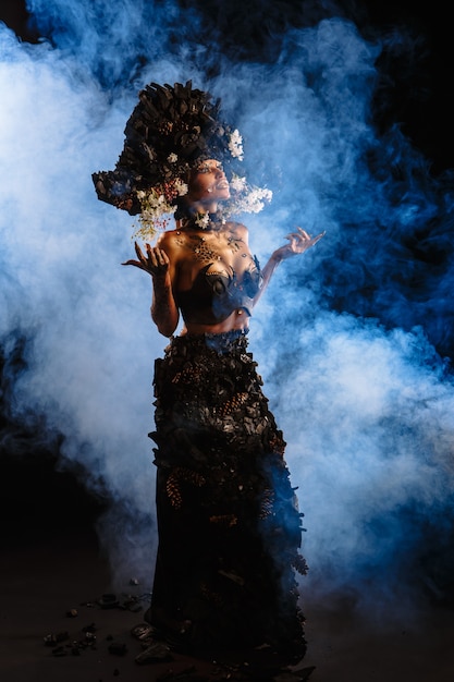 Premium Photo | Portrait of a model in a headdress and dress made of ...