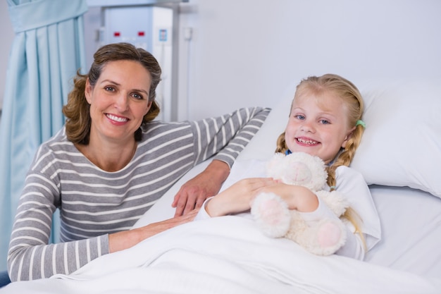 Premium Photo | Portrait of mother and daughter in hospital bed