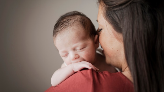 Portrait of mother holding little baby Free Photo