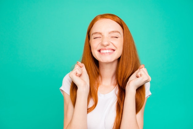 Premium Photo | Portrait nice redhead girl isolated over turquoise wall