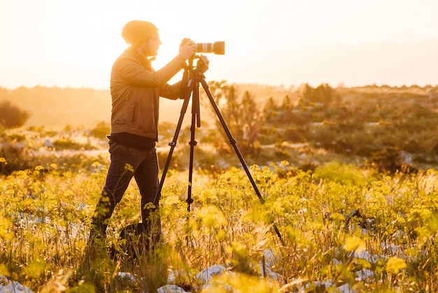 Premium Photo | Portrait of photographer making photos with camera on ...