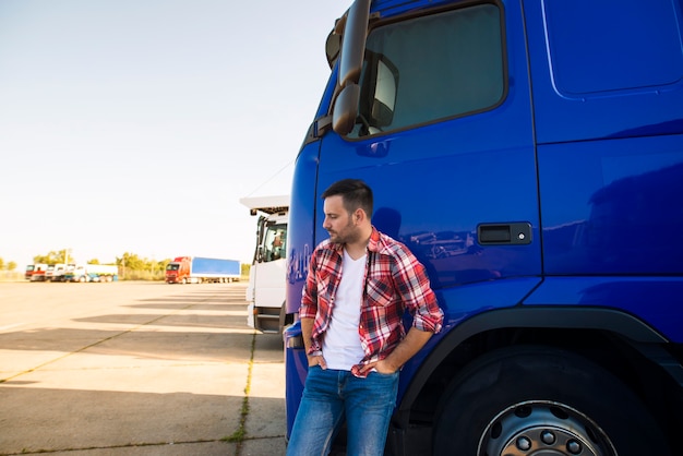 free-photo-portrait-of-professional-truck-driver-standing-by-his