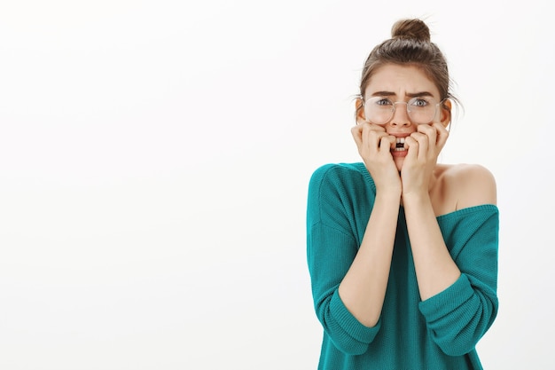 Free Photo | Portrait of scared and intimidated young woman in glasses  feeling frightened, looking horrified