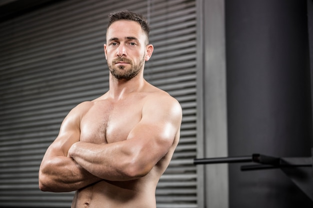 Premium Photo | Portrait of shirtless man standing with arms crossed at ...