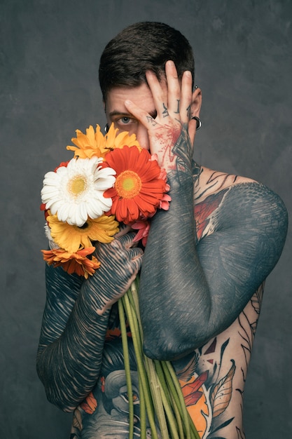 portrait-shirtless-tattooed-young-man-ho