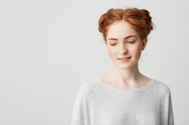 Portrait Of Shy Young Pretty Redhead Girl With Buns Looki