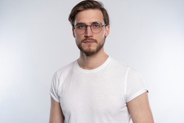 Premium Photo | Portrait of a smart young man standing against white ...