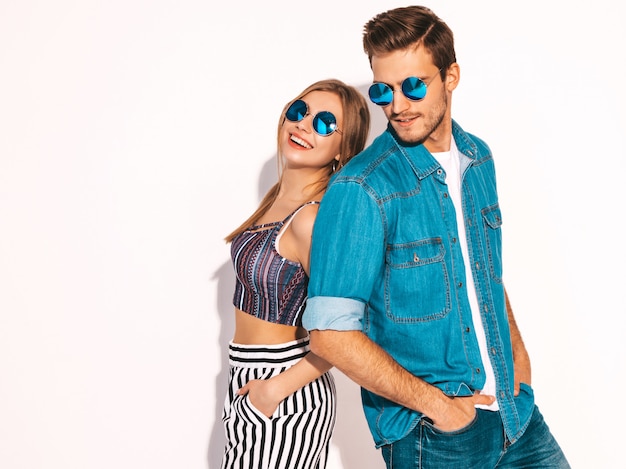 Portrait of smiling beautiful girl and her handsome boyfriend laughing.happy cheerful couple in sunglasses. Free Photo