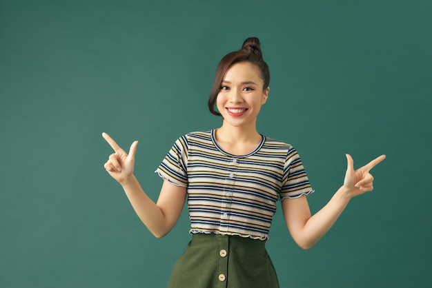 premium-photo-portrait-of-a-smiling-girl-pointing-with-index-fingers