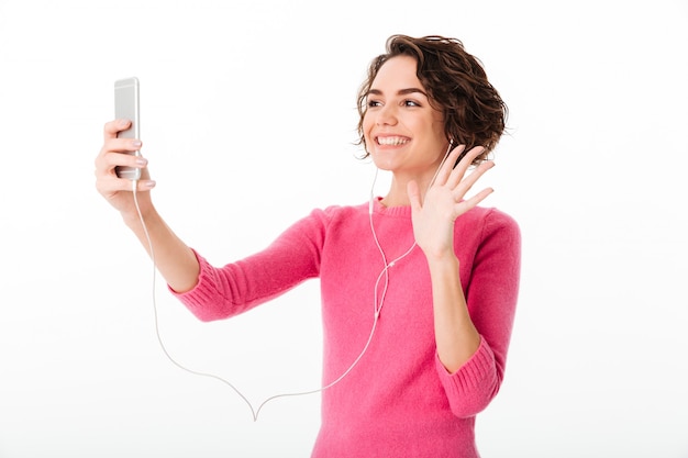 Portrait of a smiling pretty girl with earphones Free Photo