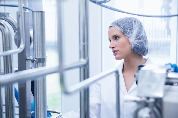 Premium Photo | Portrait of a smiling scientist behind metal pipe