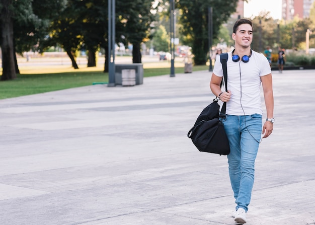 Premium Photo Portrait Of A Smiling Young Man Walking On