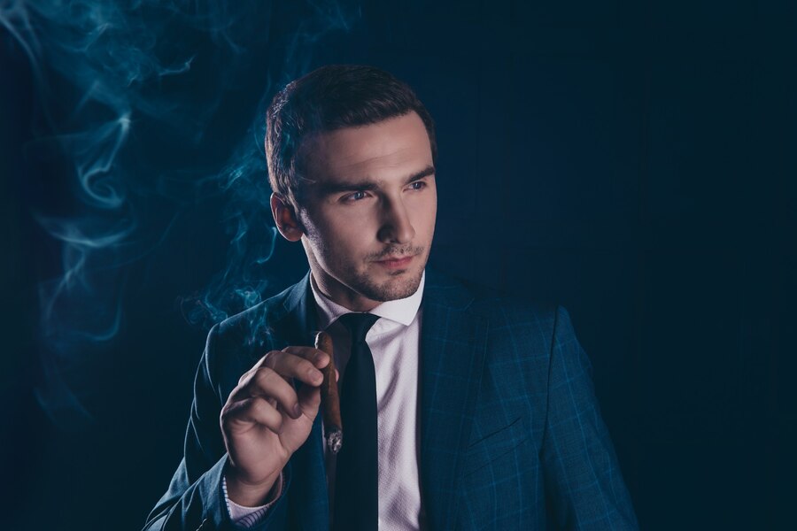 Premium Photo | Portrait of stylish man holding cigar