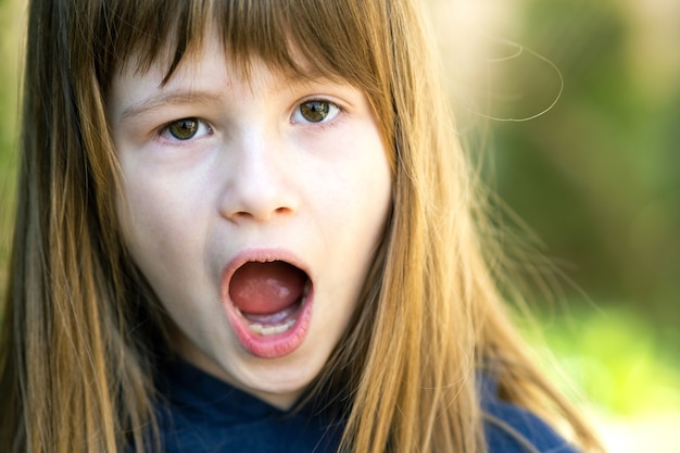 Premium Photo | Portrait of surprised child girl outdoors in summer ...