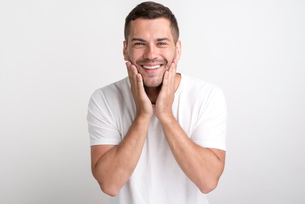 Premium Photo Portrait Of Surprised Man In White T Shirt Standing Against Plain Background