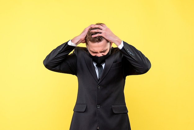 free-photo-portrait-of-tense-young-businessman-on-yellow