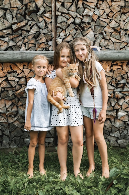 Premium Photo | Portrait of three little pretty girls, sisters, in ...