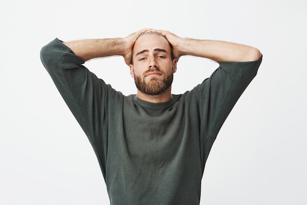 Free Photo | Portrait of tired handsome man holding hands on head