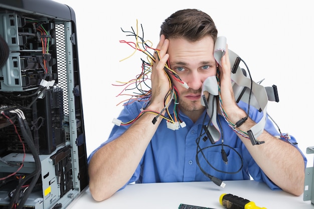 Premium Photo | Portrait of tired it professional with cables in hands