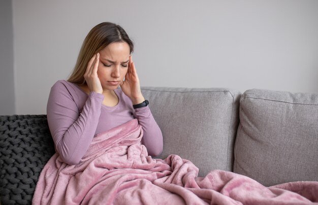 Premium Photo | Portrait of tired young woman suffering from headache