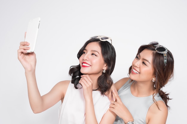 Premium Photo Portrait Of Two Beautiful Asian Fashionable Women Taking Selfie