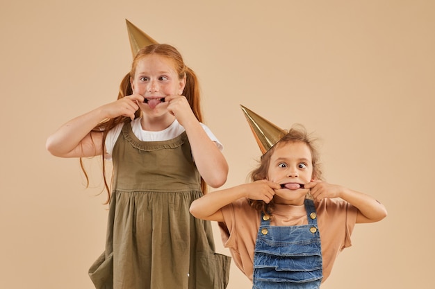 Premium Photo | Portrait of two girls making funny faces and grimacing ...