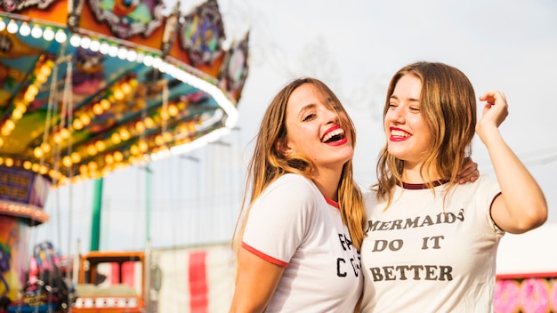 Free Photo | Portrait of two smiling young woman at amusement park