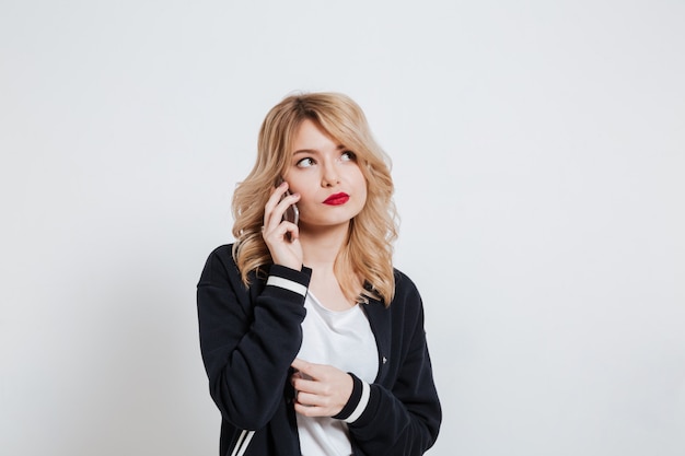 Free Photo | Portrait of an upset young casual woman talking on phone