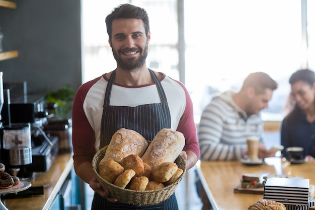 Premium Photo Portrait Of Waiter Holding A Basket Of Bread