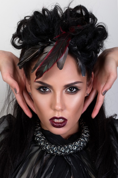 Premium Photo Portrait Of Woman Shaman With Raven Feather In Her Hair