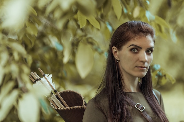 Premium Photo | Portrait of a woman with arrows in a quiver, close-up