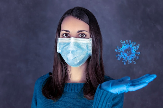 Premium Photo | Portrait of a woman with mask and gloves holding coronavirus