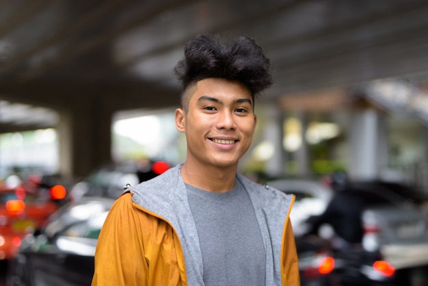 Premium Photo Portrait Of Young Asian Man With Curly Hair In The City