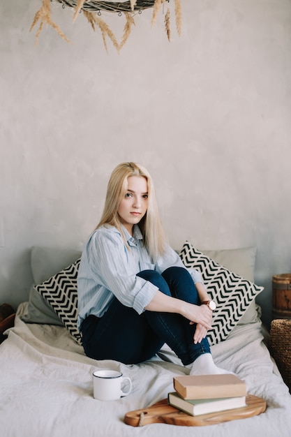 Premium Photo | Portrait of a young beautiful blonde girl in bed in the ...