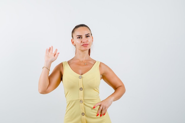 Free Photo | Portrait of young beautiful female waving hand for ...