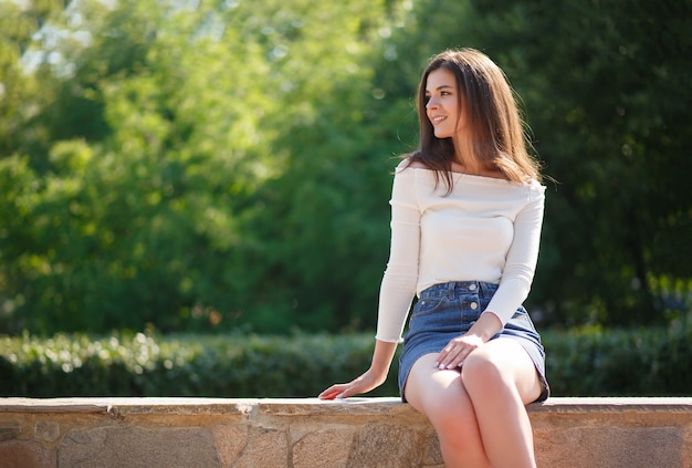 Premium Photo | Portrait of a young brunette woman in a park