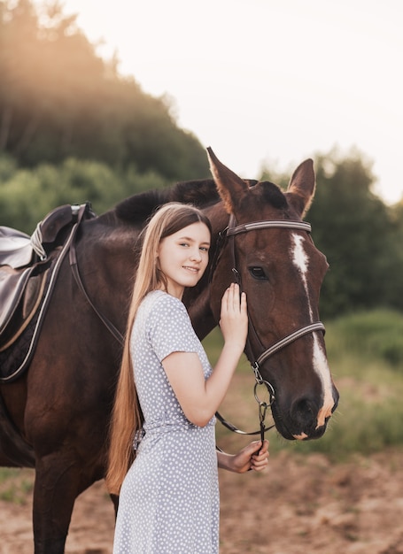 Premium Photo | Portrait of young girl standing next to a horse looking ...