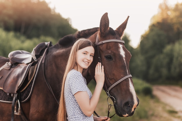 Premium Photo | Portrait of young girl standing next to a horse looking ...