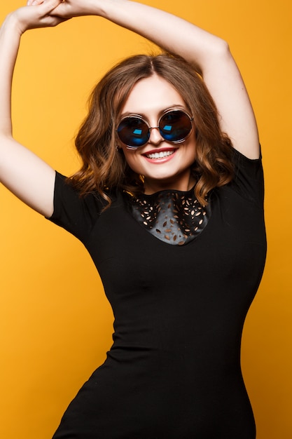 black dress with yellow accessories