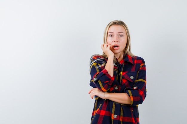 Free Photo | Portrait of young lady standing in scared pose in checked ...