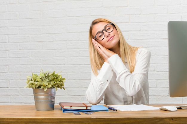 Portrait Of Young Student Sitting On Her Desk Doing Tasks Tired