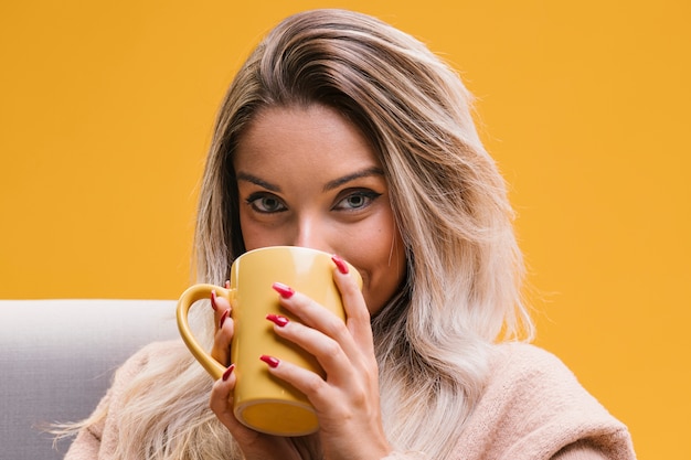 Free Photo | Portrait of young woman drinking coffee at home