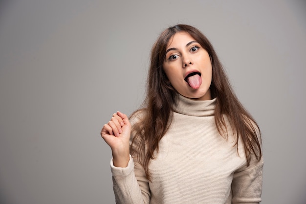 Free Photo | Portrait of a young woman posing and showing tongue