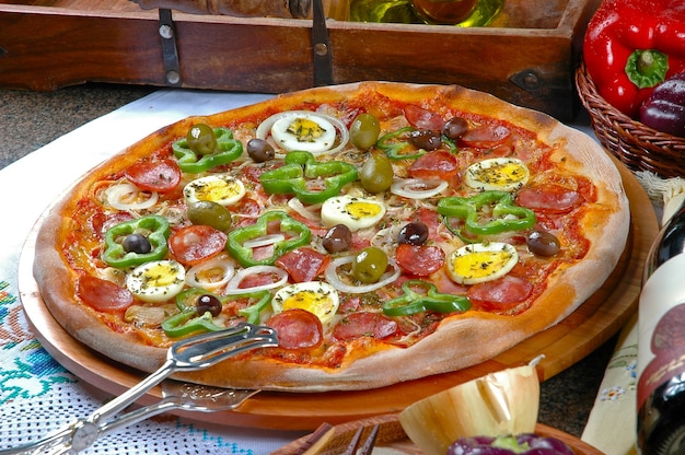 Premium Photo | Portuguese pizza, onion, peppers, pepperoni, egg, olive