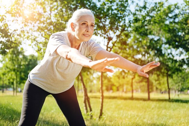 Premium Photo | Positive aged delighted woman leaning forward